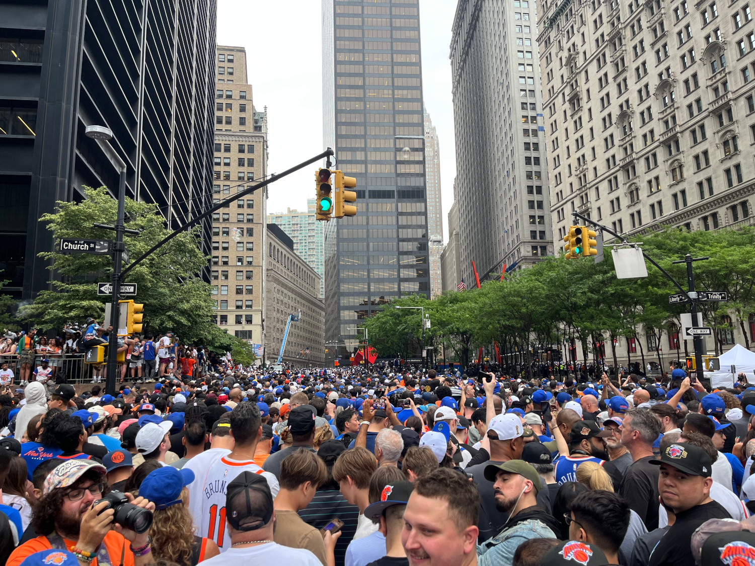 throngs of people on church looking towards Broadway