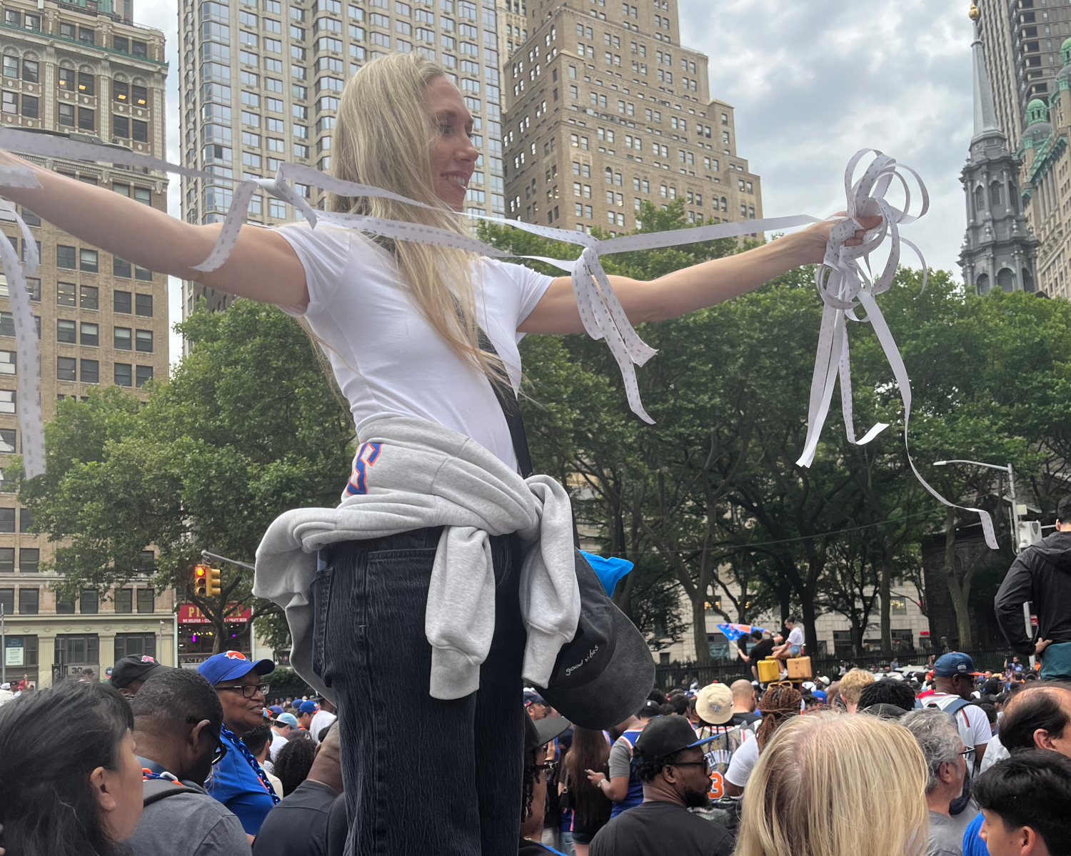 woman on bollard with ticker tape